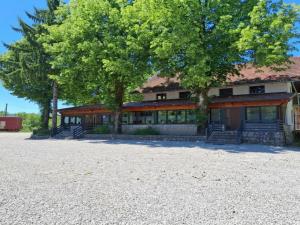 a building with two trees in front of it at Zelena Dolina in Ćuić Brdo