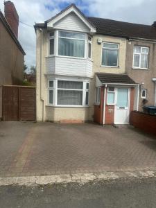 a house with a driveway in front of it at Quiet room Nr2 in Coundon