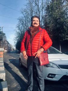 a man is standing in front of a car at Quiet room Nr2 in Coundon +3 photos