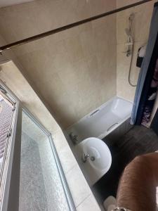 a bathroom with a white tub and a sink at Quiet room Nr2 in Coundon