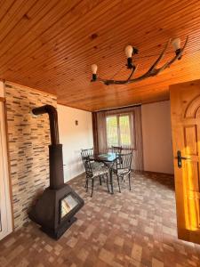 a living room with a wood stove and a table at Вила Чочита in Trapeskovtsi