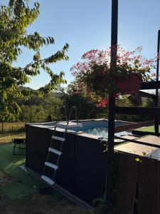 a ladder is standing next to a swimming pool at Вила Чочита in Trapeskovtsi