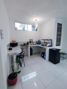 a large white room with a table and a desk at Galápagos Apartments in Puerto Ayora +7 photos