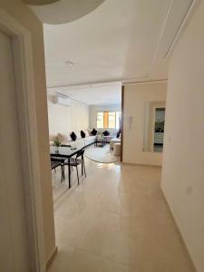 a living room with a table and a couch at Al Hoceima Luxury Residence Amina 3 in Al Hoceïma +9 photos