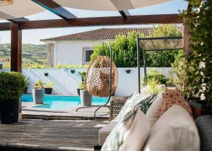 a patio with a couch and a swimming pool at Casa Relogio de Sol in Lamego