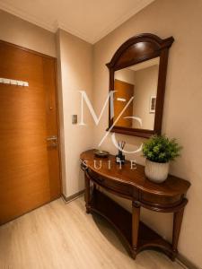 a bathroom with a wooden vanity and a mirror at Disponible Exclusivo Depto Central. Clinica Antofagasta. Wi-Fi Parking y Factura in Antofagasta
