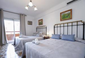 a bedroom with two beds with blue pillows at Villa Cococha in Salou