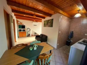 a kitchen and dining room with a table and chairs at Zelena Dolina in Ćuić Brdo +11 photos