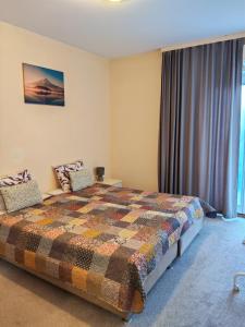 a bedroom with a bed and a large window at Apartmani Svitlana in Sukošan
