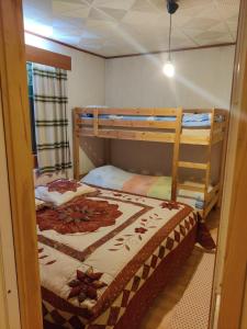 a bedroom with two bunk beds and a ladder at Aurora Grande in Saariselka