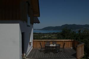 a wooden deck with a table and chairs on it at Haus Dorfinger in Aufham