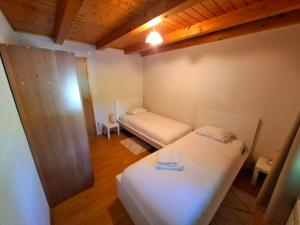 a small room with two beds and a couch at Zelena Dolina in Ćuić Brdo