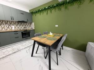 a dining room with a wooden table and chairs at Emerald House 5 in Scheia