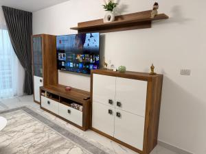 a living room with a tv on the wall at Emerald House 5 in Scheia