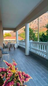a balcony with a table and chairs and a view at Blue Eye Nature Escape 