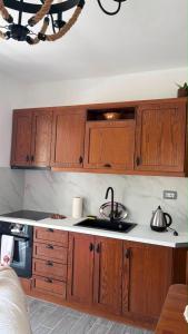 a kitchen with wooden cabinets and a stove top oven at Blue Eye Nature Escape  +3 photos