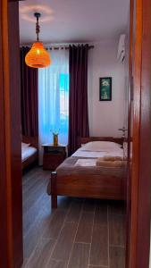 a bedroom with a bed and a chandelier at Blue Eye Nature Escape 