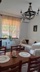 a living room with a table and a couch at Blue Eye Nature Escape 