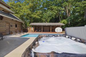 a pool with a hot tub in the middle of a yard at Wilder Woods in Michiana