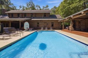 a large swimming pool in front of a house at Wilder Woods in Michiana