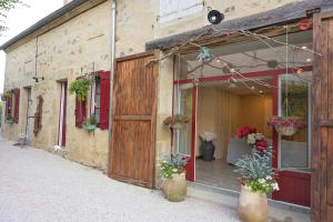 a building with potted plants on the side of it at Rouges-Gorges  +4 photos