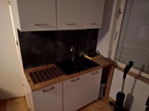 a kitchen with a sink and a counter top at W Częstochowie in Częstochowa