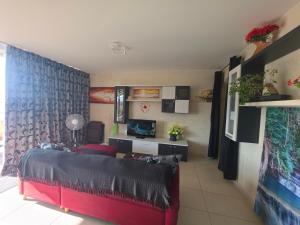 a living room with a red couch in a room at Il Bejta penthouse in Qala