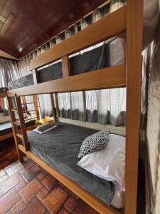 a bedroom with bunk beds in a room with at Numa Boa HOSTEL Búzios in Búzios +113 photos