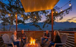 a group of people sitting around a fire pit at Artbliss Hotel in Stevenson +112 photos