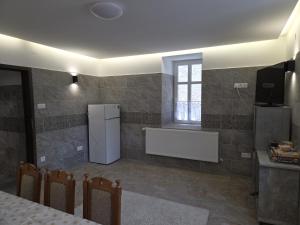 a kitchen with a refrigerator and a window at Happyzem in Sátoraljaújhely +60 photos