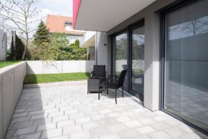 a patio with two chairs and a window at Alleenstraße 66 in Wendlingen am Neckar