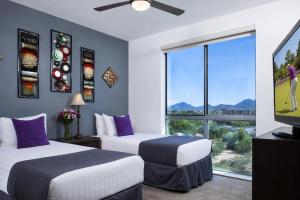 two beds in a room with a large window at Luxury Condos by Meridian CondoResorts- Scottsdale in Scottsdale +53 photos