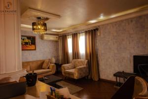 a living room with a couch and a chair at Hotel Résidence La Falaise in Douala