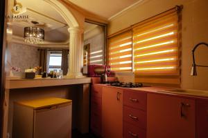 a kitchen with a sink and a stove top oven at Hotel Résidence La Falaise in Douala +49 photos