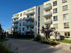 an apartment building with balconies on the side of it at Marigold Apartment Łódź in Łódź