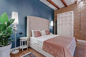 a bedroom with a bed and a brick wall at Eiffel Grand View in Paris