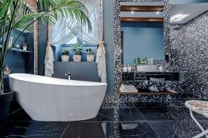 a bathroom with a white tub and a sink at Eiffel Grand View in Paris +132 photos
