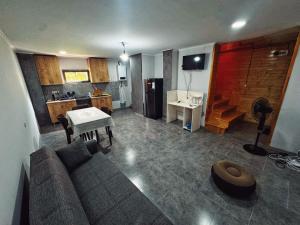 a living room with a couch and a kitchen at Casa nostra in Ambrolauri