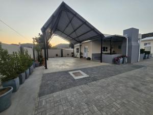 a large building with a roof with a patio at Rosa's Self-catering in Springbok