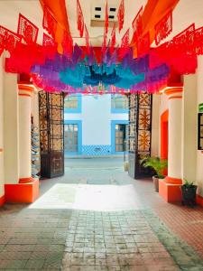 an entrance to a building with red and blue at Hotel Antequera in Oaxaca City