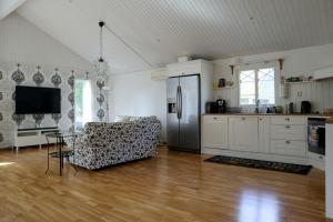 a kitchen and living room with a couch and a table at Villa near Åhus in Yngsjö +8 photos
