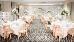 a banquet hall with white tables and chairs at Holiday Inn Southend by IHG in Southend-on-Sea