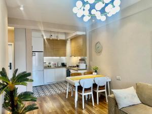 a kitchen and living room with a table and chairs at Eiffel Grand View in Paris