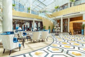 a lobby with chairs and tables in a building at InterContinental Doha The City by IHG in Doha