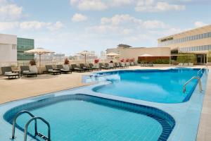 a large swimming pool on the roof of a hotel at Crowne Plaza Dubai Deira by IHG in Dubai