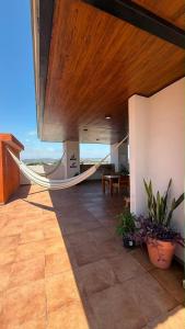 a porch with a hammock in a house at Departamento San Lorenzo #102 in Mazatlán