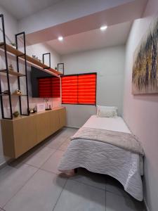 a bedroom with a bed and a red window at Departamento San Lorenzo #102 in Mazatlán +37 photos
