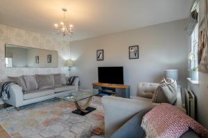 a living room with a couch and a television at 4 Bed in Amble oc-gd1868 in Amble