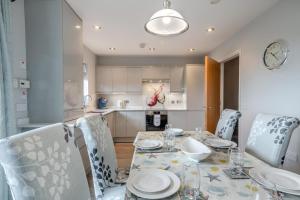 a dining room with a table and chairs and a kitchen at 4 Bed in Amble oc-gd1868 in Amble