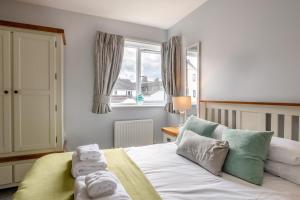 a bedroom with a bed with towels on it at 4 Bed in Amble oc-gd1868 in Amble